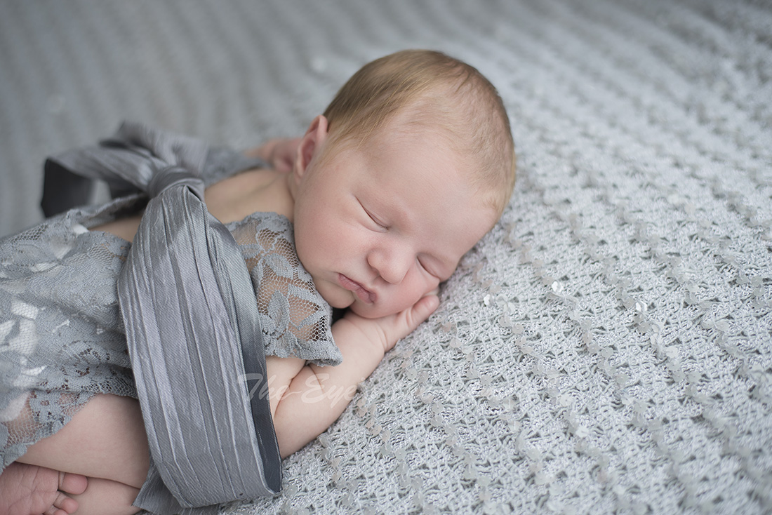 Newborn Photographer in Puslinch Ontario photographs cute baby girl in grey outfit